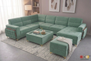 Luxurious L-shaped emerald green velvet sectional sofa with gold legs and matching ottoman.